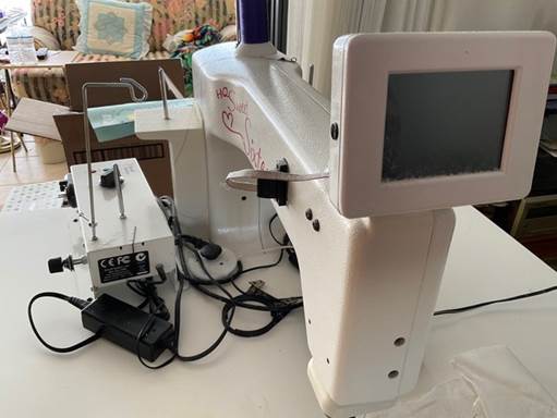 A sewing machine on a table

Description automatically generated