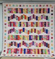 A colorful quilt with squares

AI-generated content may be incorrect.